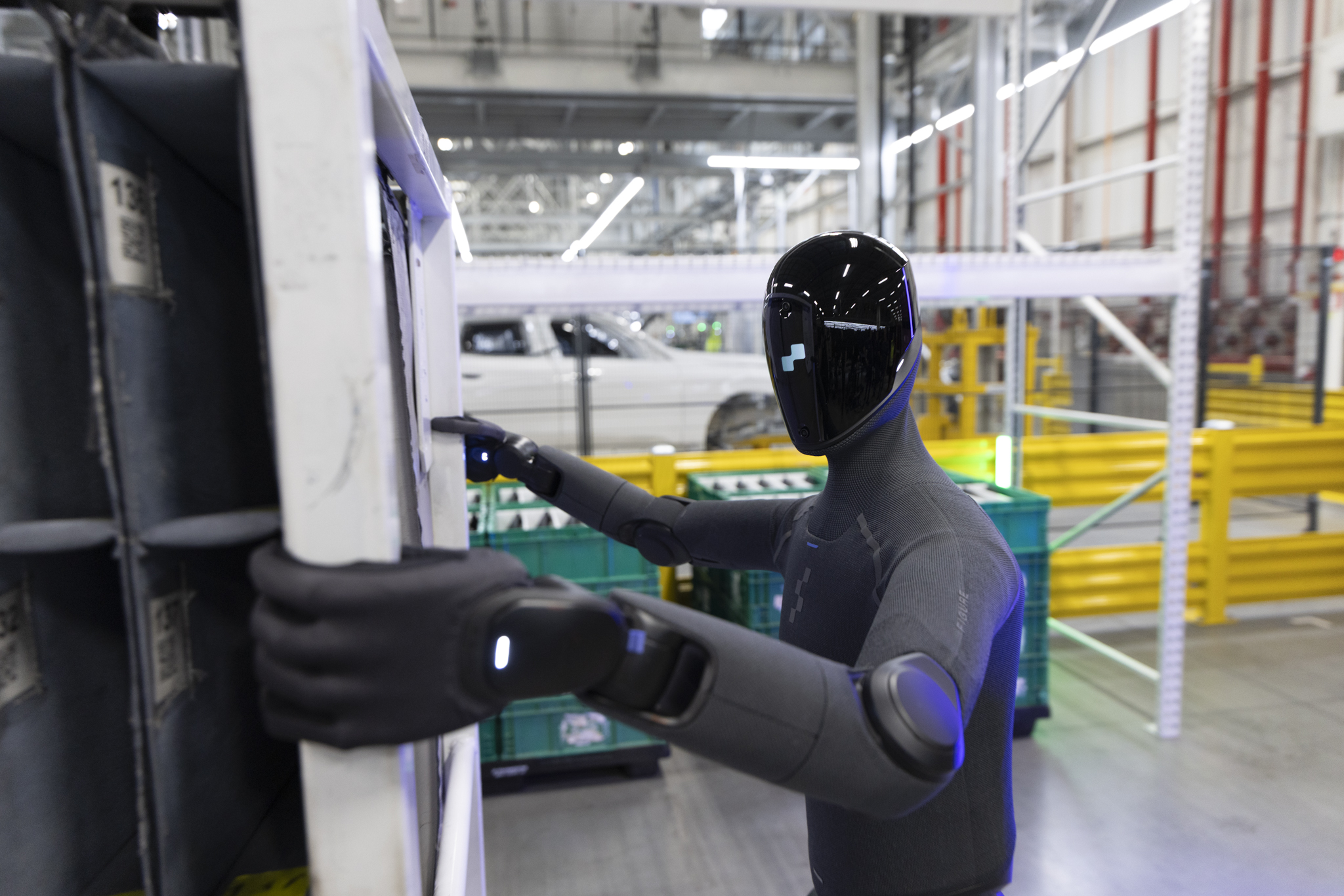 A Figure 03 humanoid robot handling parts logistics on the production line at BMW Group Plant Spartanburg.