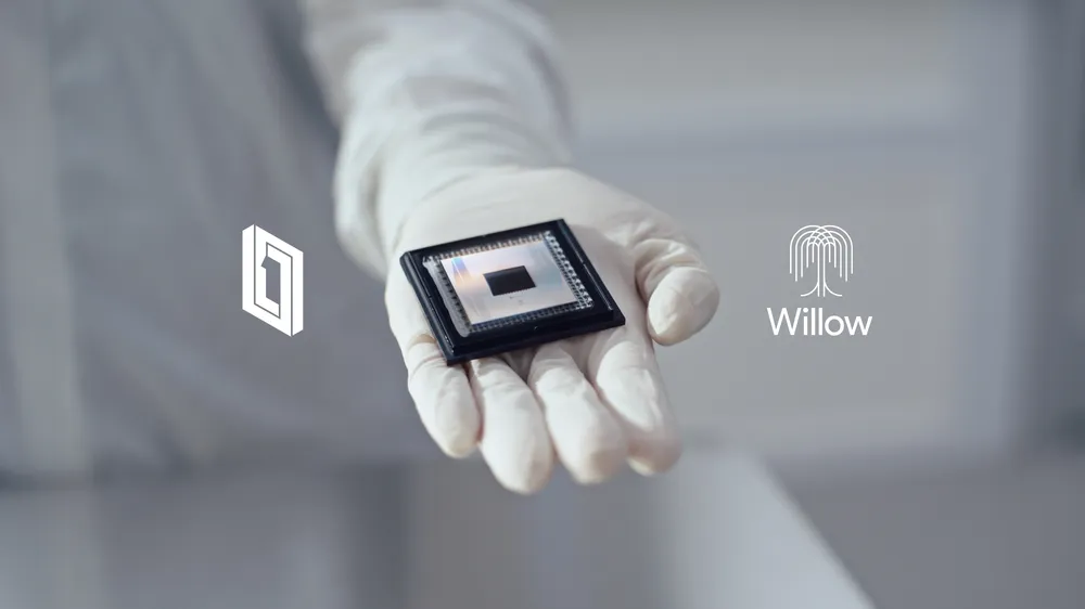 Google Willow 105-qubit superconducting quantum chip held in a gloved hand